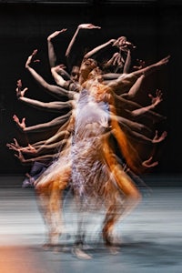 a group of dancers with their arms outstretched